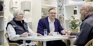 Eine Frau und ein Mann sitzen an einem Besprechungstisch und unterhalten sich